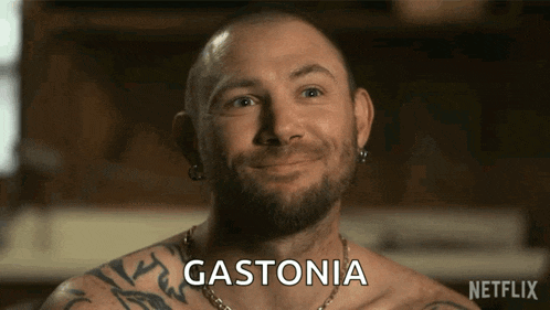 a man with a beard and tattoos is smiling and says gastonia on the screen