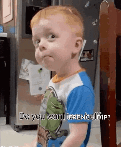 a baby is making a funny face while standing in front of a refrigerator and asking do you want french dip .