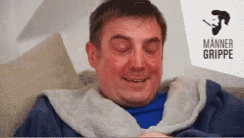 a man is sitting on a couch with his eyes closed in front of a sign that says manner grippe .