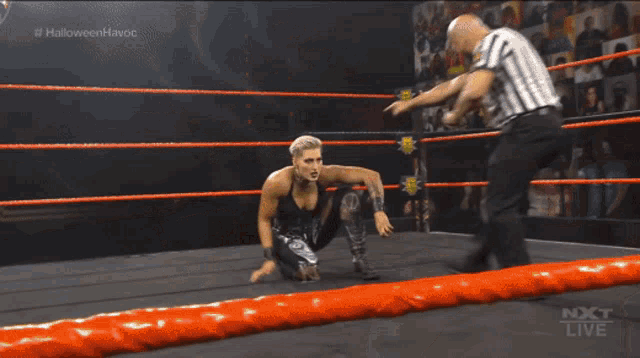 two women wrestling in a ring with the words halloween honors on the bottom right