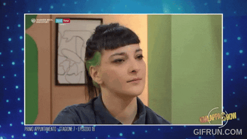 a woman 's face is displayed on a screen that says gifrun.com in the corner