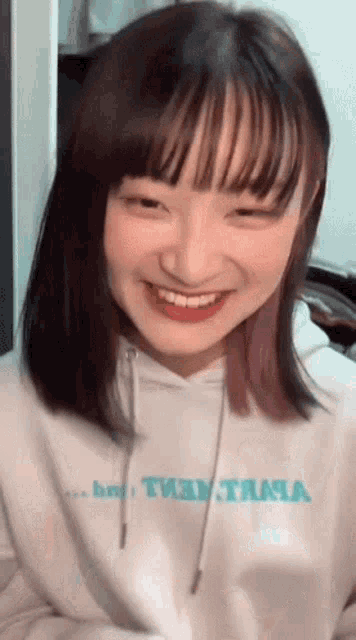 a girl with purple hair is wearing a white hoodie that says tiny tama