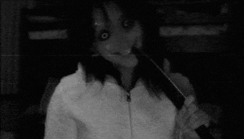 a black and white photo of a woman in a white sweater