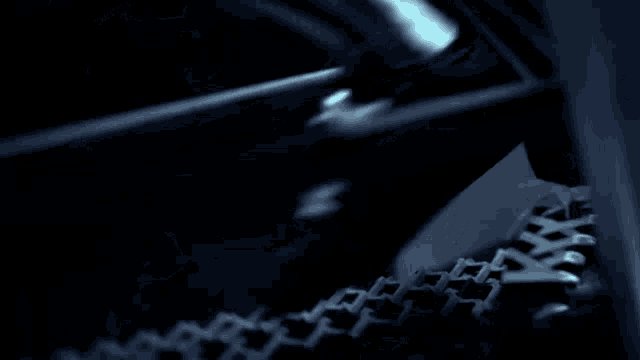 a blurry picture of a person in a dark room with a blue light behind them