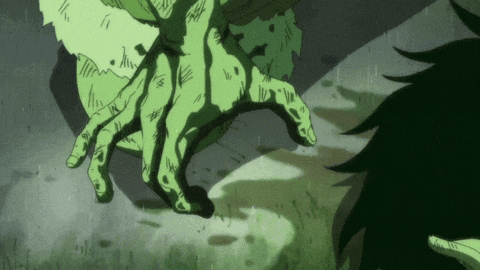 a green hand is reaching out towards a person 's face