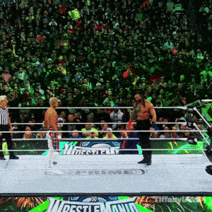 two men in a wrestling ring with a sign that says wrestlemania