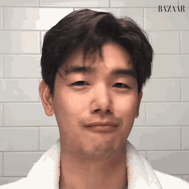 a close up of a man 's face with the word bazaar on the bottom right