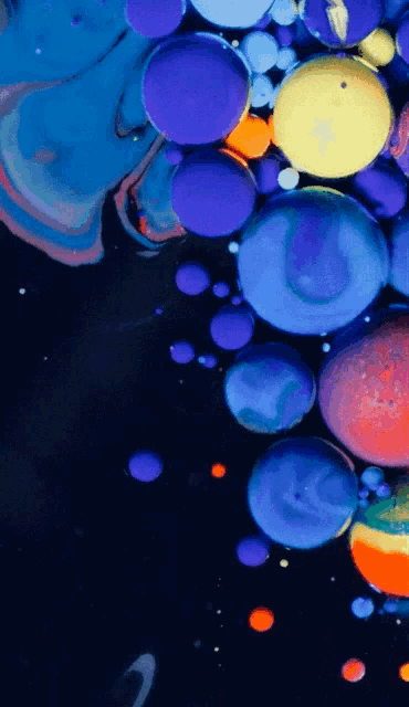 a bunch of colorful bubbles on a dark background