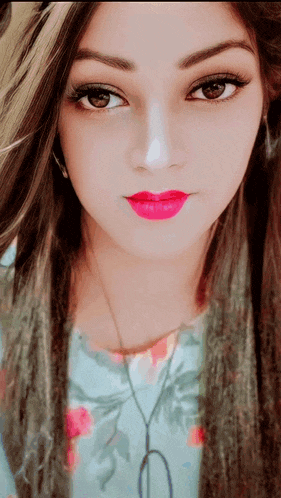 a close up of a woman wearing pink lipstick