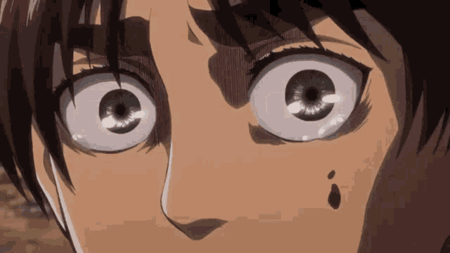 a close up of a person 's face with a tear coming out of his eye .