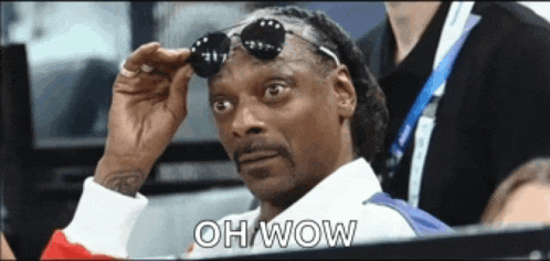 snoop dogg is wearing sunglasses and says oh wow in the corner