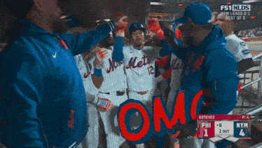 a group of mets baseball players holding a sign that says " omg "