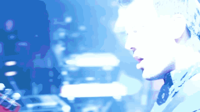 a blurry picture of a man playing a guitar