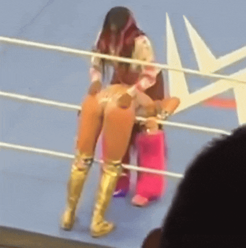 a woman in gold boots is standing in a ring