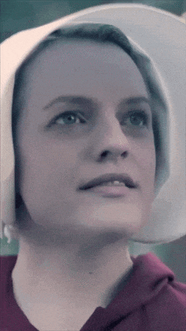 a close up of a woman 's face with a white hat on