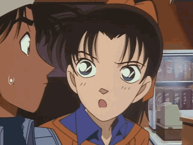 a girl with a surprised look on her face is standing next to a boy