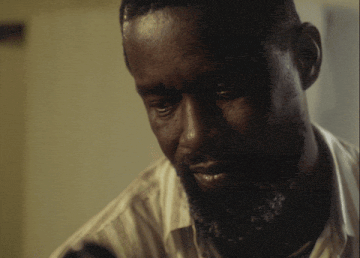 a close up of a man 's face with the words abeg free the matter above him