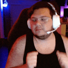 a man wearing headphones and a black tank top is sitting in a chair