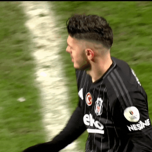 a soccer player wearing a black jersey that says eto