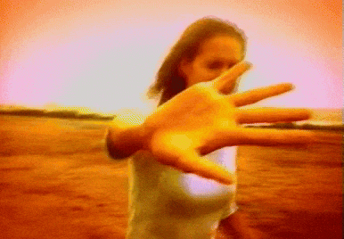 a blurred image of a woman reaching out her hand