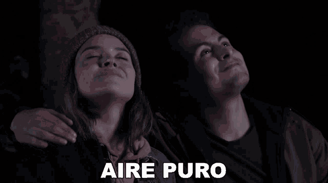 a man and a woman are looking up with the word aire puro written in white
