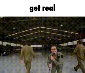 a man is singing into a microphone in a warehouse with the words get real above him