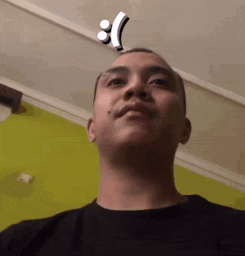 a man with an exclamation point on his head looks at the camera