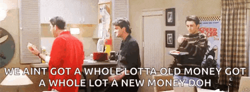 a man in a red shirt is talking to another man in a living room .