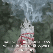 a person is holding a stick of white sage with smoke coming out of it and a quote .