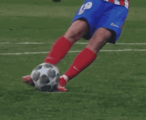 a soccer player with the number 19 on his shorts kicking the ball