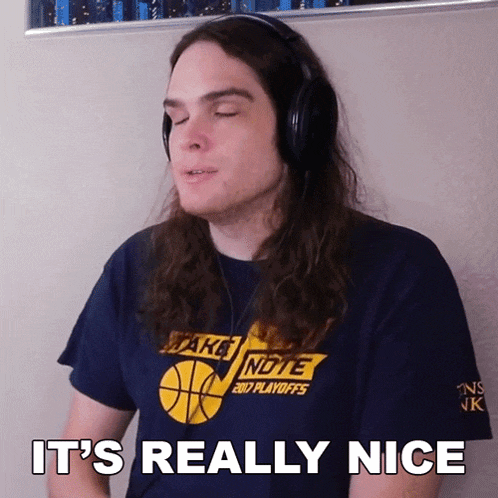 a man wearing headphones and a t-shirt that says take note on it