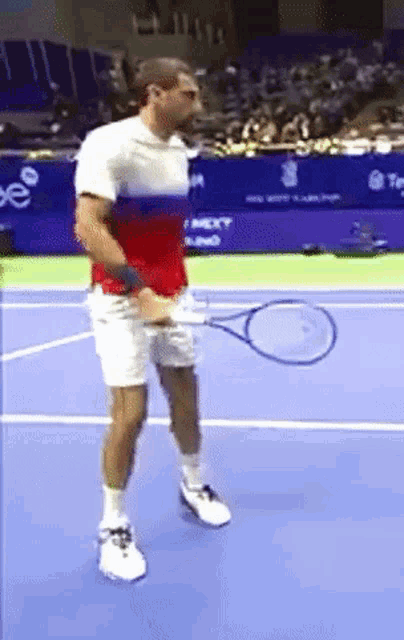 a man holding a tennis racquet on a court