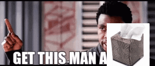 a man is pointing at a box of kleenex and the words get this man a