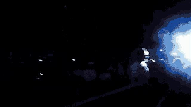 a dark room with a few lights on the ceiling