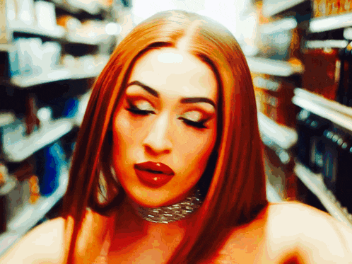 a woman with long red hair and a choker on her neck