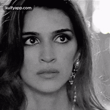 it is a black and white photo of a woman 's face .