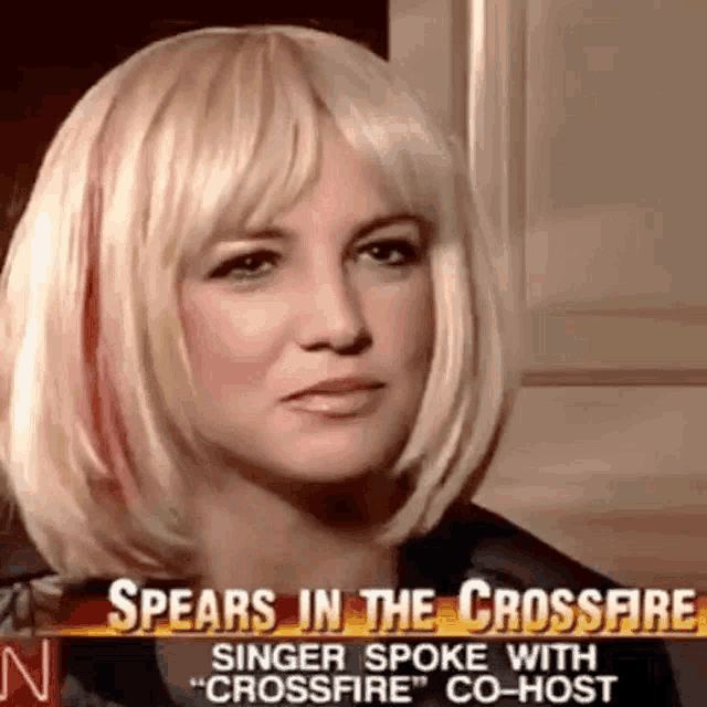 a close up of a woman 's face with a headline that says ' spears in the crossfire ' on it