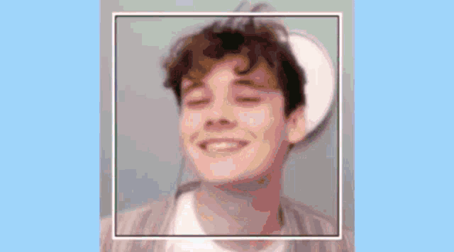 a close up of a young man 's face with his eyes closed .