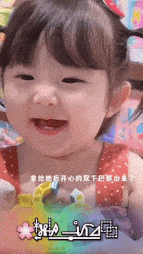 a little girl is smiling in front of a sign that says xperia