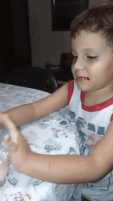 a young boy wearing a shirt that says ' a ' on it
