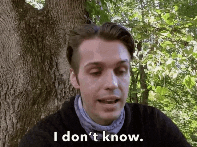 a man says " i don 't know " while standing in front of a tree