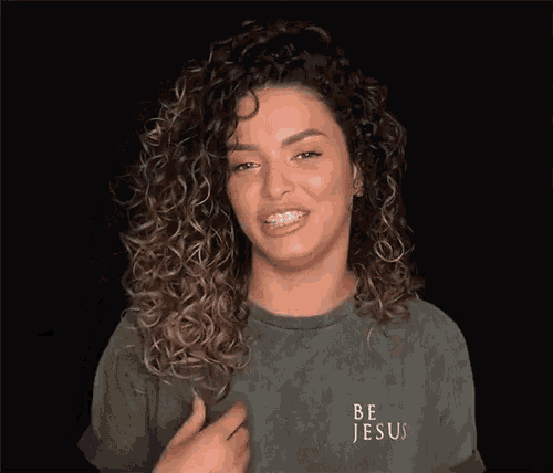 a woman with braces on her teeth wears a shirt that says be jesus