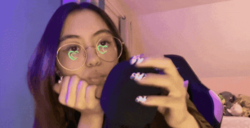 a woman wearing glasses is taking a selfie