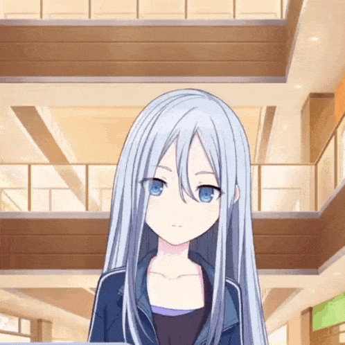 a girl with long white hair and blue eyes is standing in a large building .