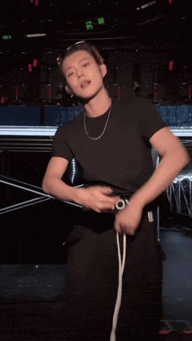 a person wearing a black shirt that says hoy on the waist