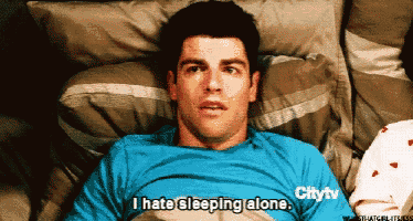 a man is laying in bed with the words i hate sleeping alone on his shirt