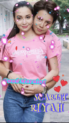 a woman in a pink shirt hugs another woman in a pink shirt