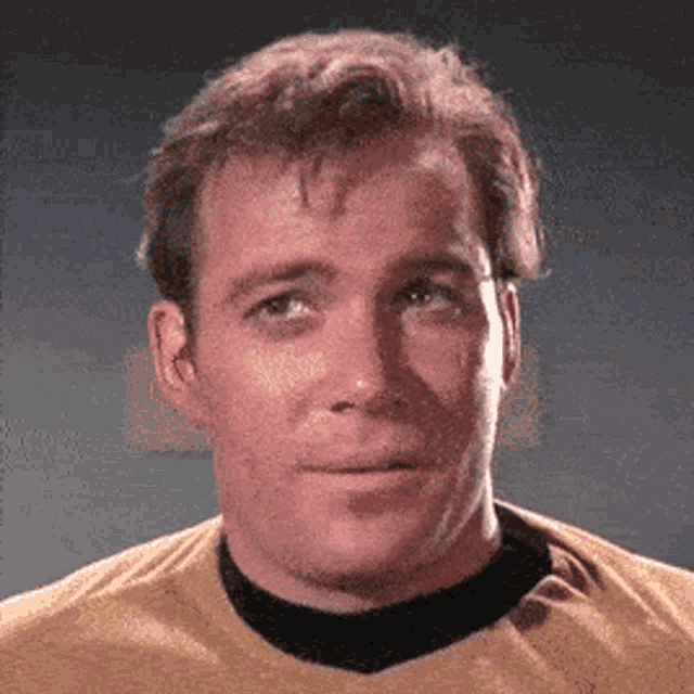 a close up of a man wearing a yellow shirt and black collar