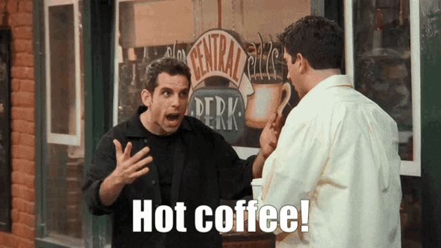 two men are standing in front of a coffee shop and one of them is saying hot coffee