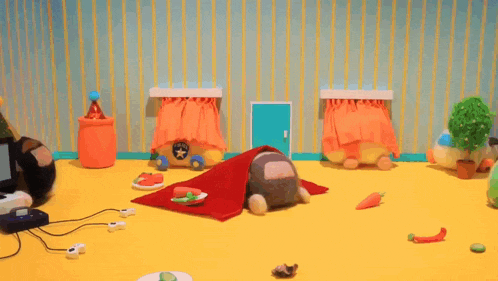 a bunch of stuffed animals are sitting on top of a yellow table .